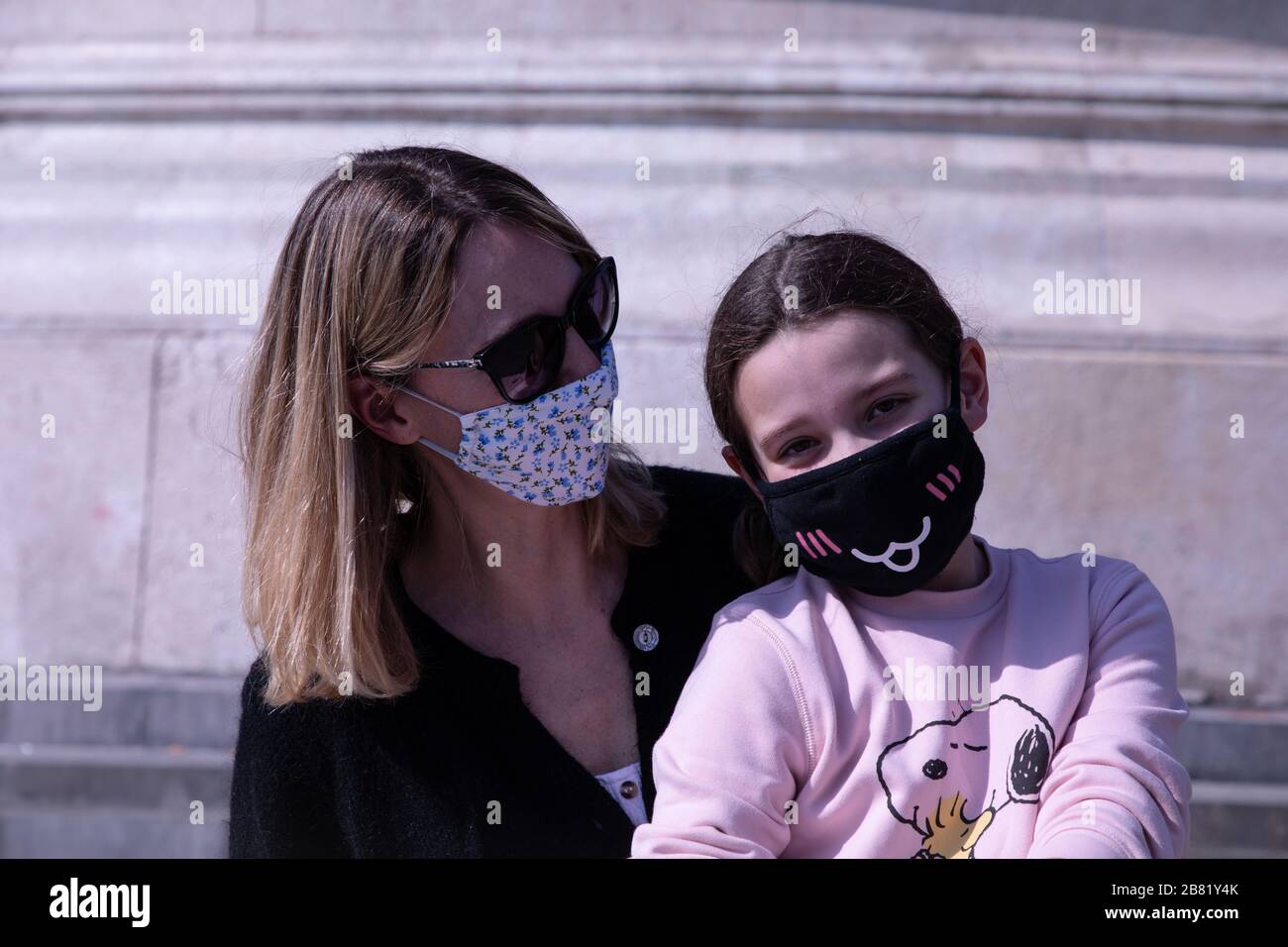 Angelique and her daughter Oceane (10 years old) wear face masks as a