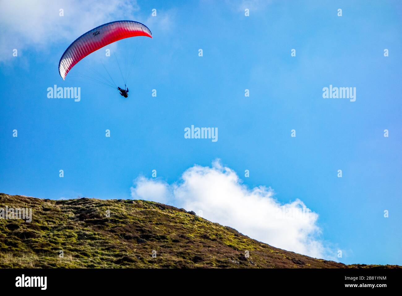 People hang gliding in the rolling hills of the English Peak District