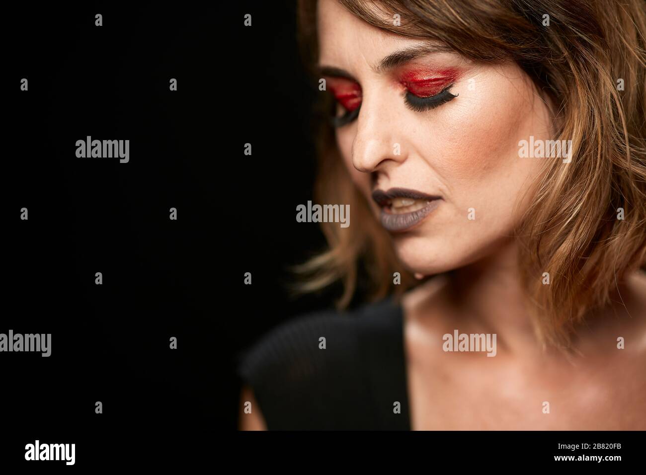 Portrait of Woman with Red Eyeshadow and False Eyelashes Stock Photo
