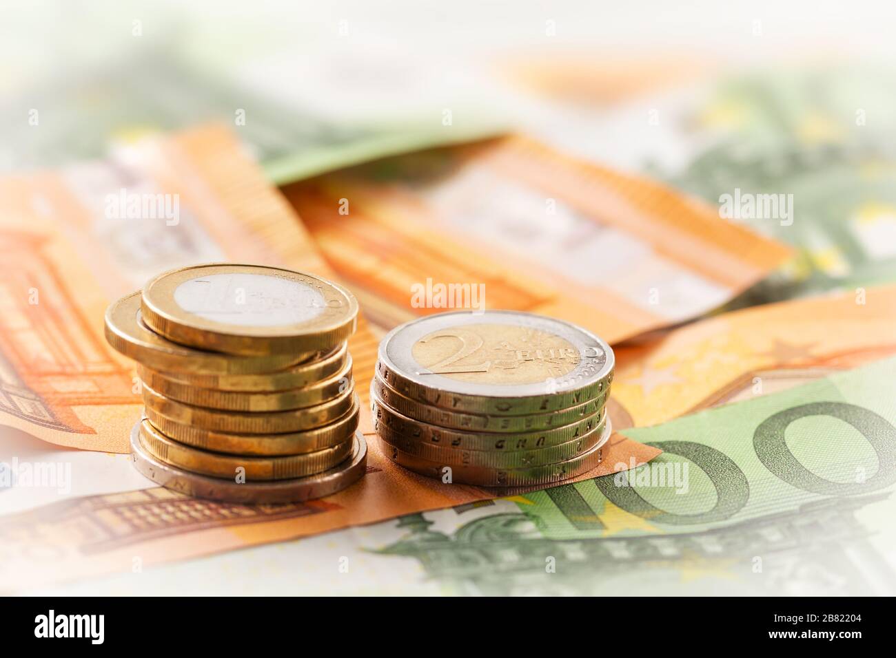 Stack of euro coins on euro banknotes, for backgrounds and with copy ...