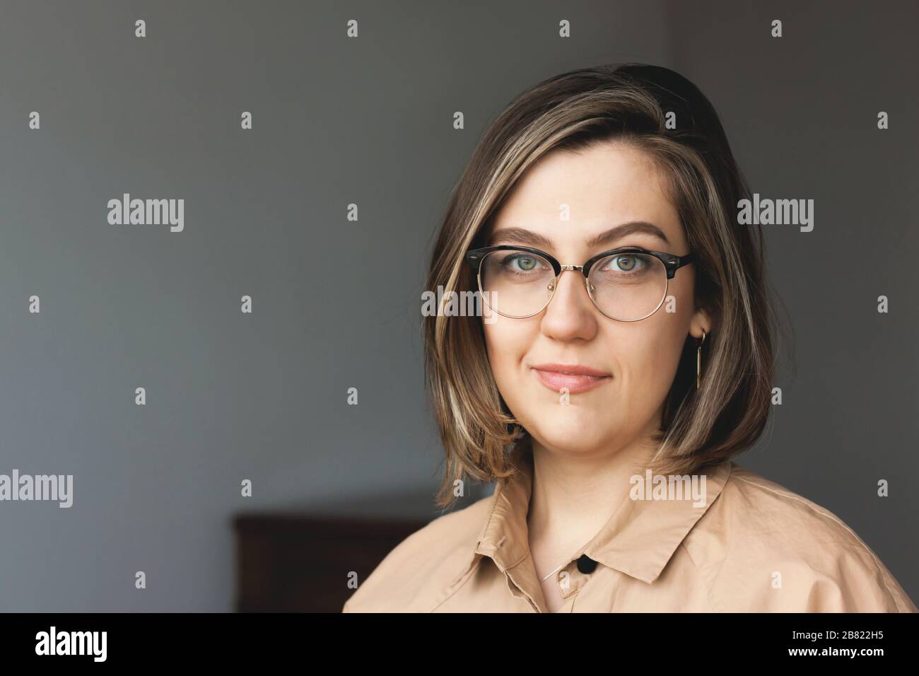 Portrait of stylish intellectual credible woman. Nice smile, glasses. The concept of a doctor, psychologist, psychiatrist, blogger, designer. Stock Photo
