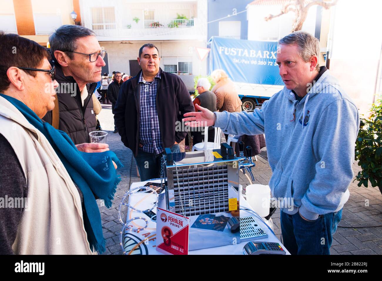 Brewer from micro craft brewery promoting his beer in a village Spanish market Stock Photo