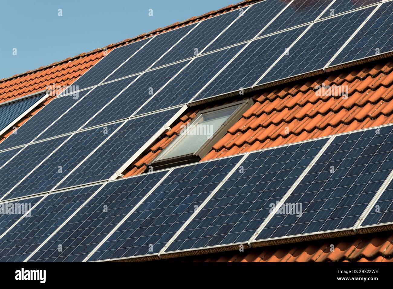 Solar panel on a red roof Stock Photo - Alamy