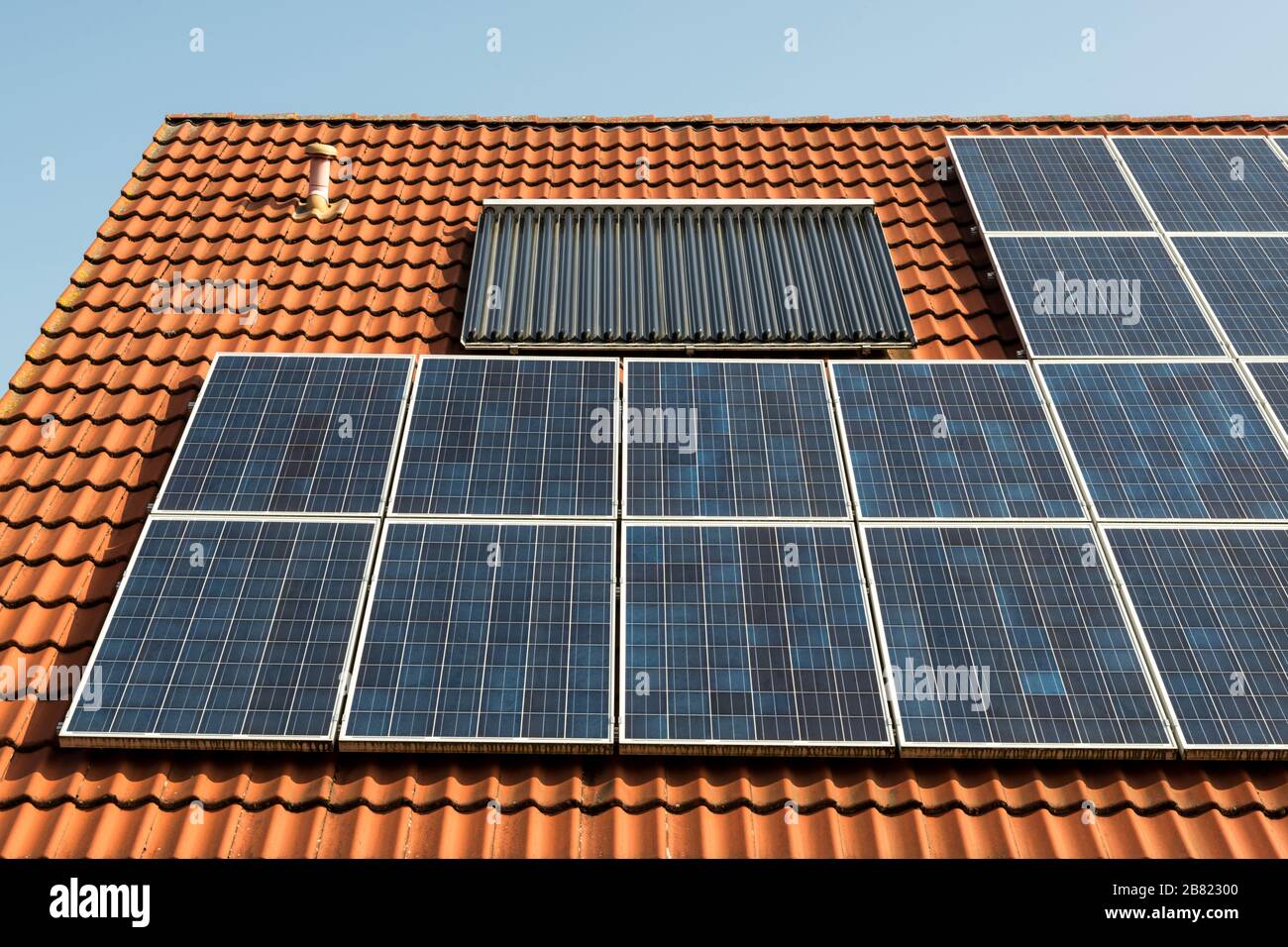Solar panel on a red roof Stock Photo - Alamy