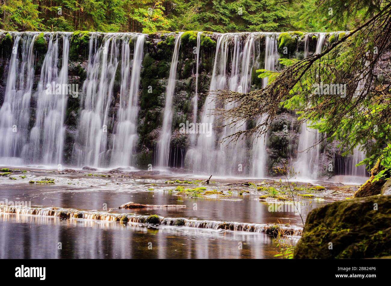 large waterfall on a mountain river in the forest Stock Photo