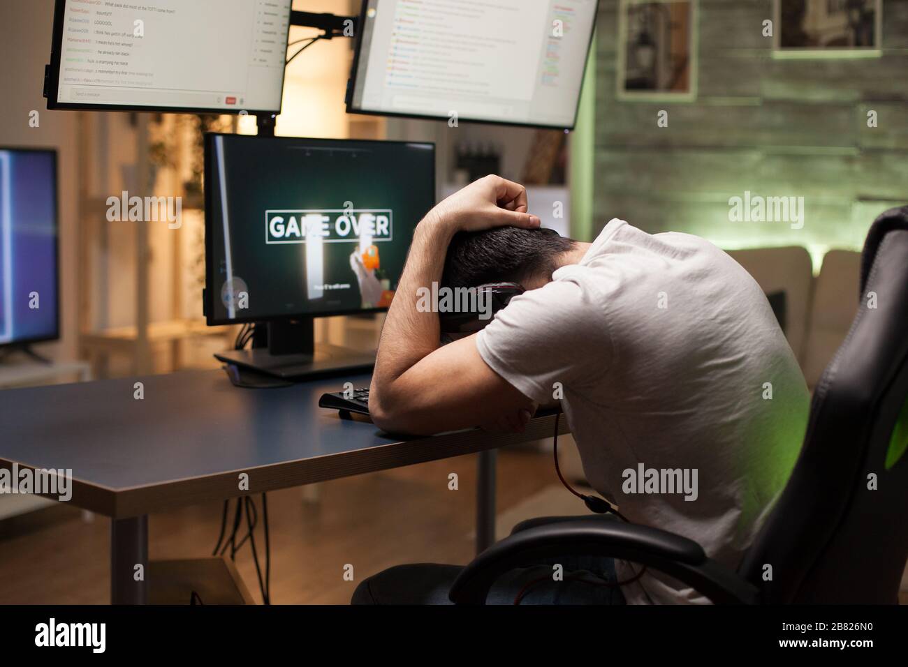 Young man upset after losing at shooter game on stream. Game over. Stock Photo
