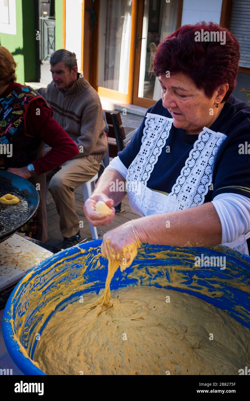 Spanish Ladies making Bunuelos Buñuelo in local village market Stock Photo