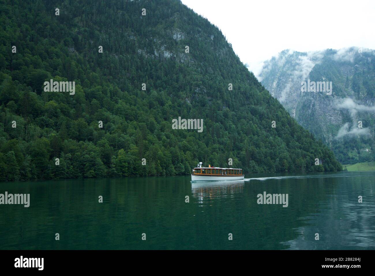 Tourist boat on Königssee / Kings Lake, Berchtesgaden National Park, Bavarian Alps, Bavaria, Germany. Tour Boat on a lake in the mountains, Konigsee. Stock Photo