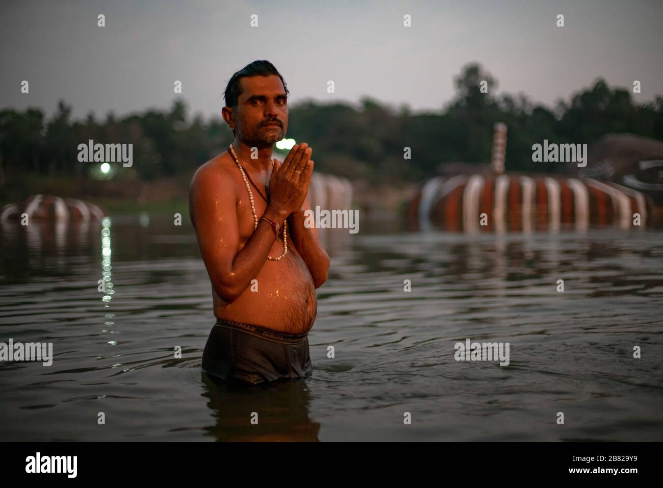 An Indian man performs her ritual purifications in the Tungabhadra