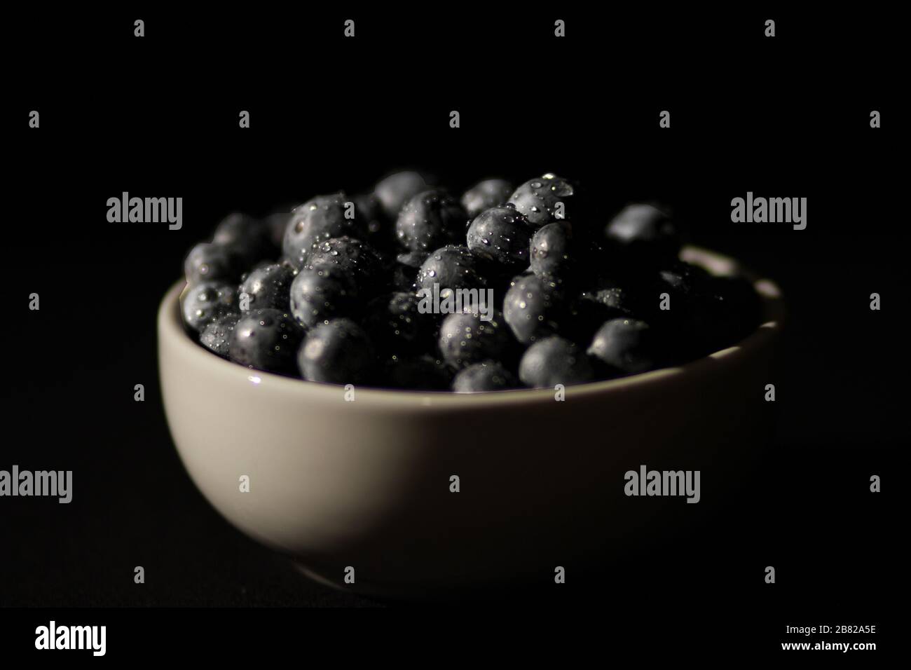 High Contrast bowl of blueberries Stock Photo