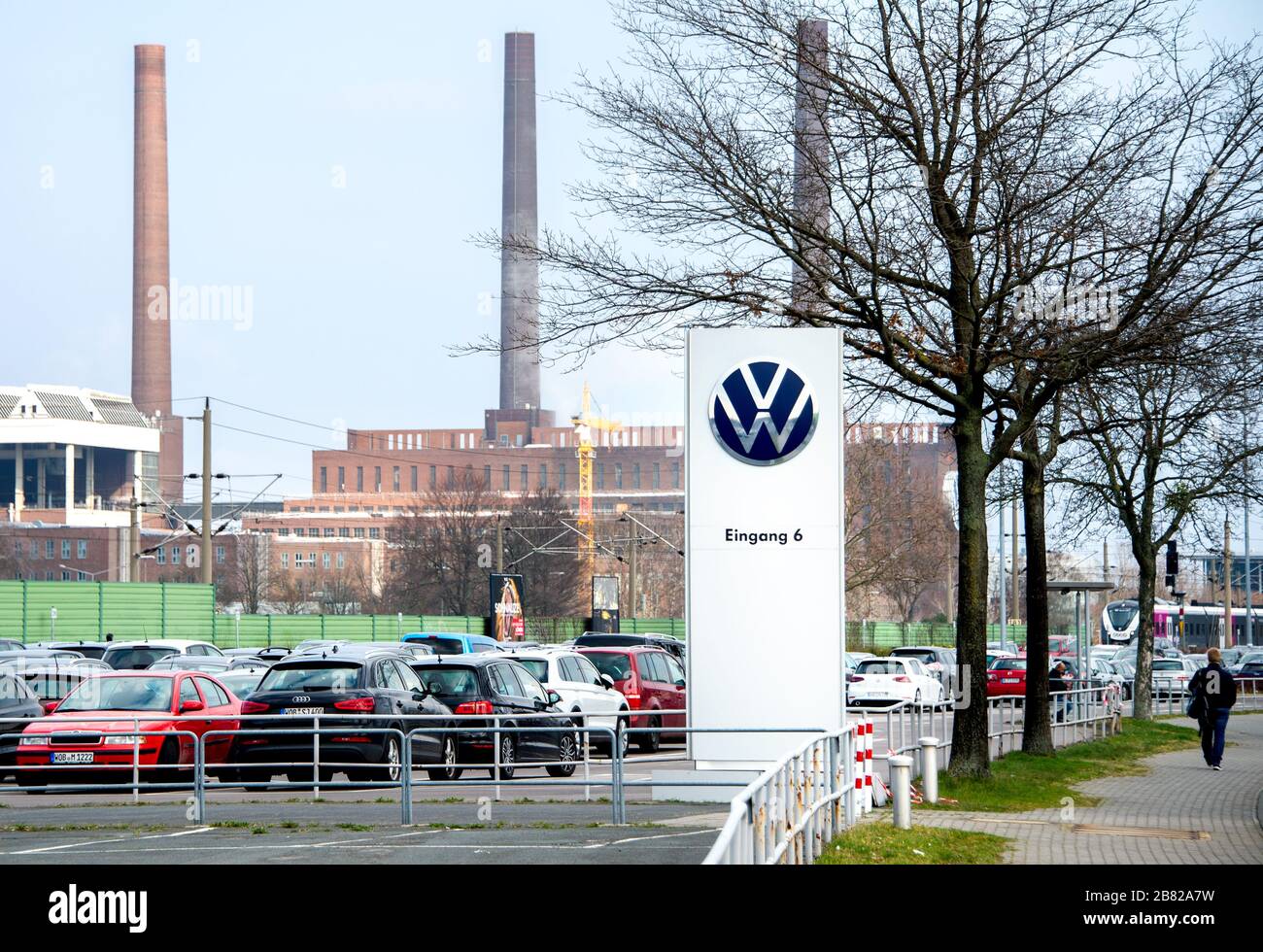 19 March 2020, Lower Saxony, Wolfsburg: The Volkswagen AG logo is located at the entrance to an employee parking lot in front of the plant. The growing risk of infection and the drastic economic consequences of the corona crisis will force Volkswagen to close its plants in Germany from Thursday evening (March 19, 2020). Photo: Hauke-Christian Dittrich/dpa Stock Photo