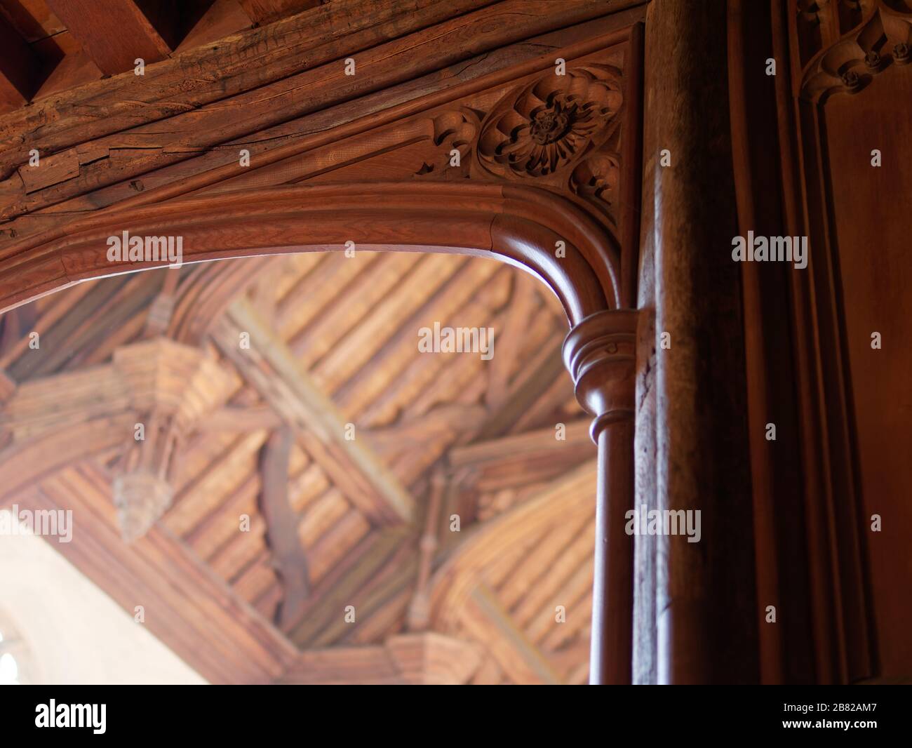 Detail of wooden decorative spandrel in the Great Hall, Eltham Palace. Hammerbeam roof in the background. Stock Photo