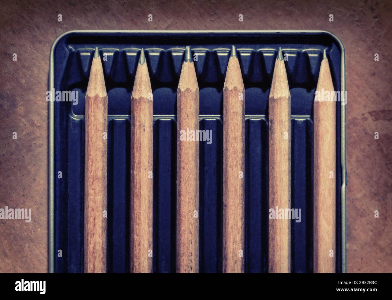 Wooden pencils in a box, separated by an empty space. Concept picture for social distancing. Stock Photo