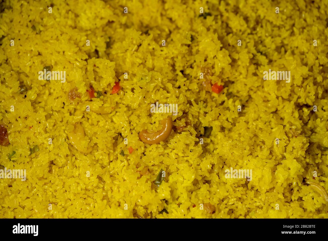 Delicious authentic bengali spicy yellow pulao cooked at a huge amount for indian wedding. Concept for regional Bengali traditional food Cuisine. Stock Photo