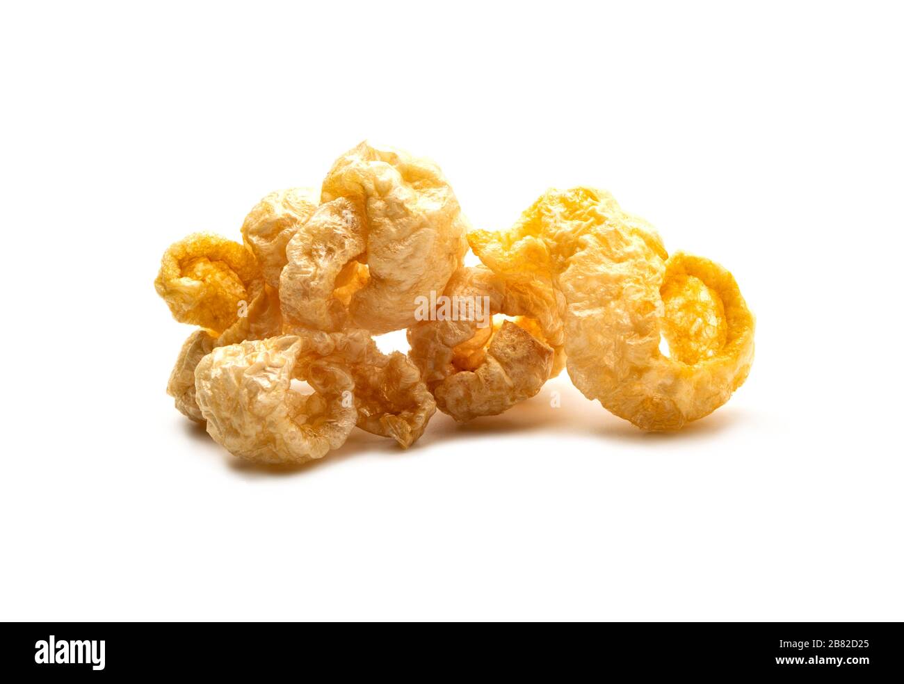Pork snack crispy and blistered isolated on white background. Crispy pork skin pieces. Food concept. Stock Photo
