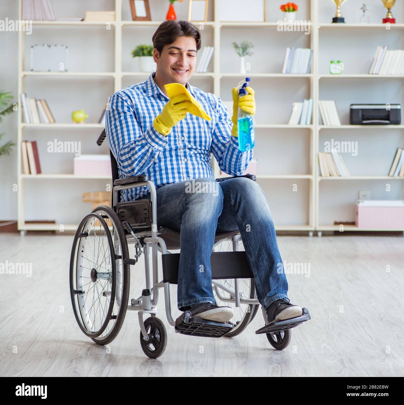 The disabled man on wheelchair cleaning home Stock Photo Alamy