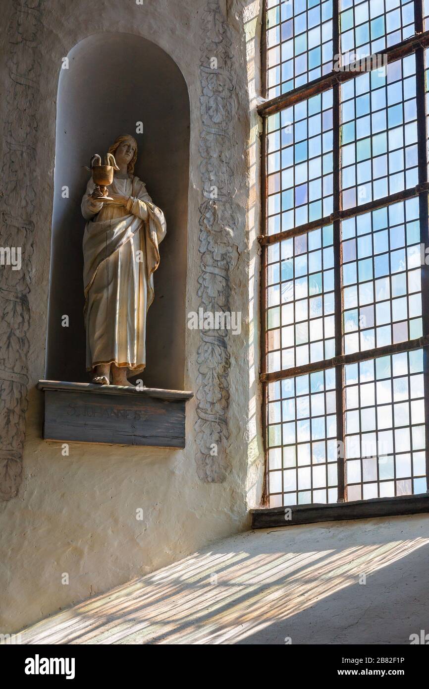 Statue in a church window with beautiful color changes Stock Photo - Alamy