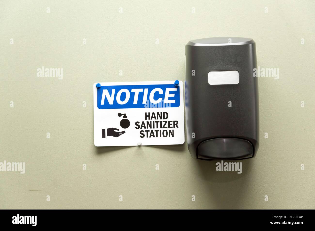 Hand sanitizer dispenser on the wall in a restaurant in North Florida. Stock Photo