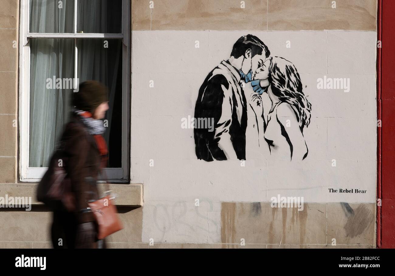 A piece of art by the artist, known as the Rebel Bear has appeared on a wall on Bank Street in Glasgow. The new addition to Glasgow's street art is capturing the global Coronavirus crisis. The piece features a woman and a man pulling back to give each other a kiss. Stock Photo