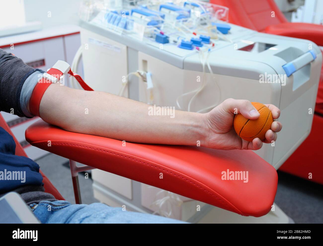 Arm pressing the ball for better blood pressure. Preparing for taking