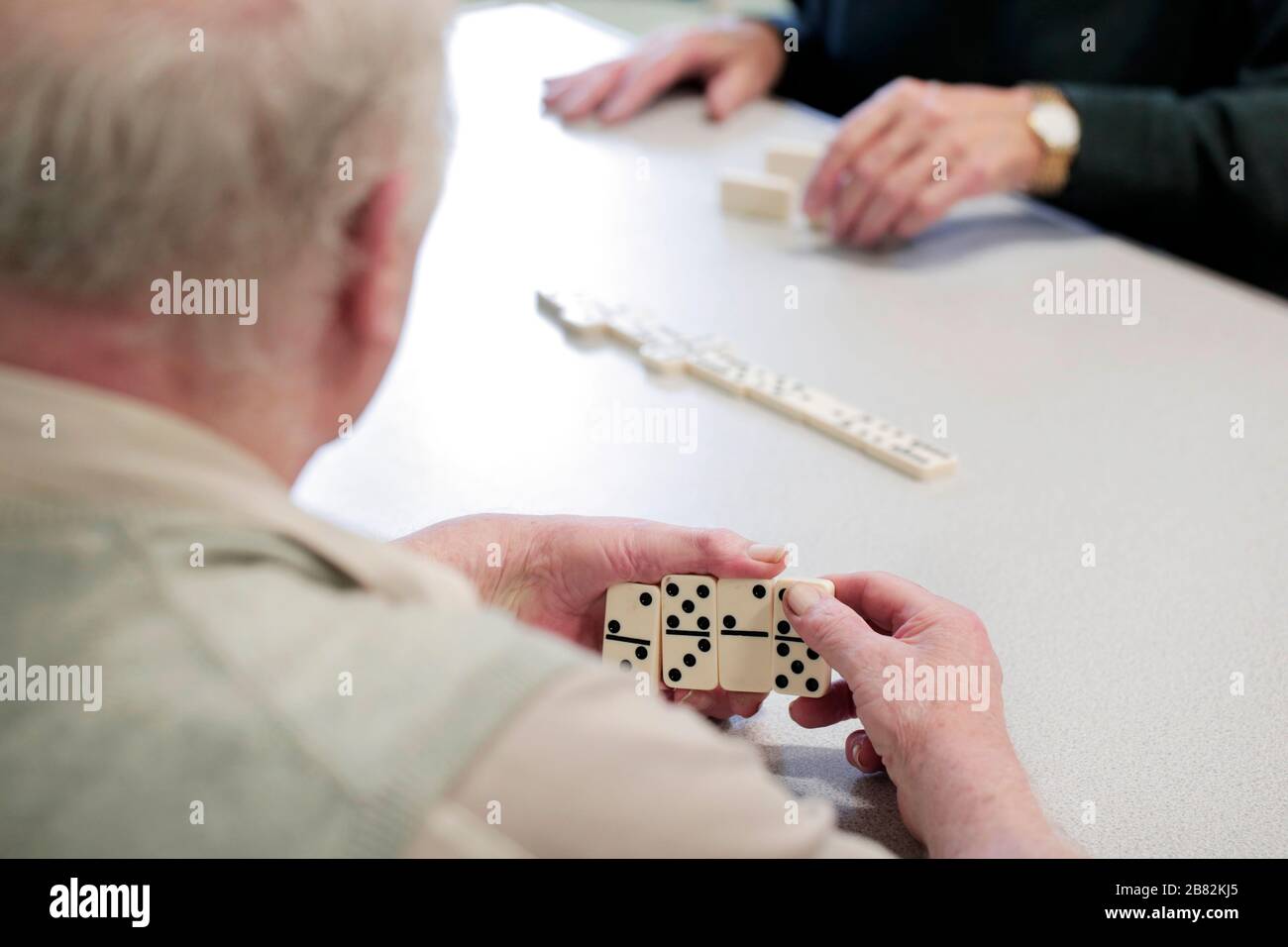 Playing dominoes at the pensioners social group, North Ormesby Community Hub, Middlesbrough, Teesside, UK. 28/1/2020. Photograph: Stuart Boulton Stock Photo