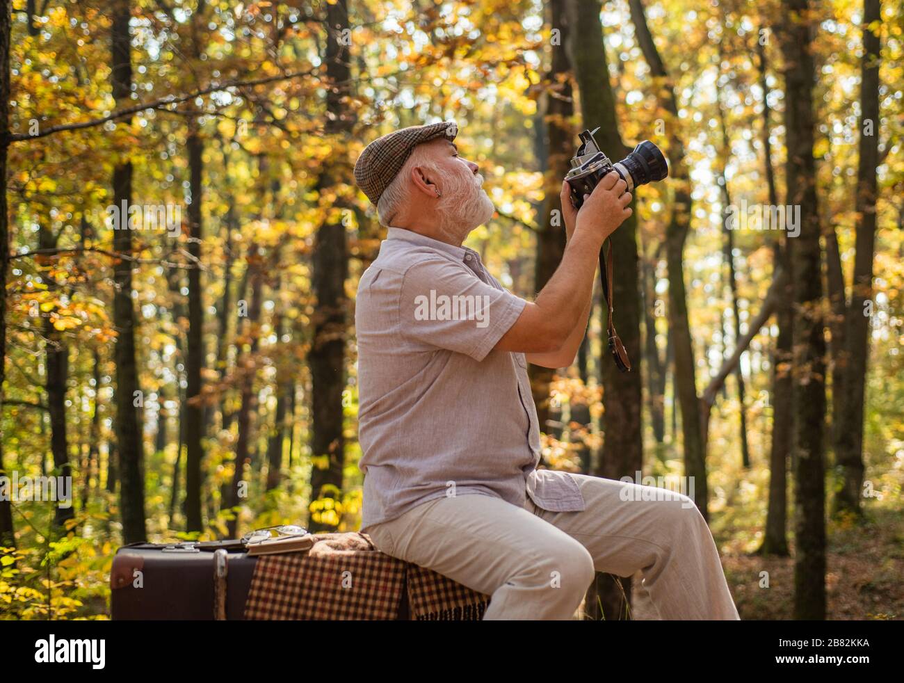 Shooting autumn session. Old man shoot in nature. Landscape and nature  photo shooting. Using handheld shooting. Hobby and lifestyle. Shooting,  filming and camerawork. Fall photoshoot Stock Photo - Alamy