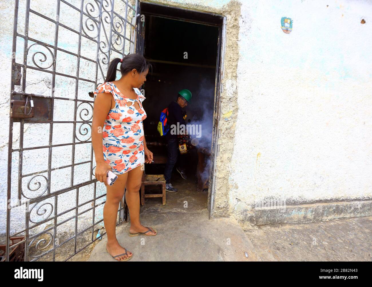 Valencia, Carabobo, Venezuela. 19th Mar, 2020. March 9, 2020, A worker performs fumigation work in residences in various sectors of the city, as a way to prevent other diseases that may arise during the Coronvirus outbreak (Covid-9). In Valencia, Carabobo state. Photo: Juan Carlos Hernandez. Credit: Juan Carlos Hernandez/ZUMA Wire/Alamy Live News Stock Photo