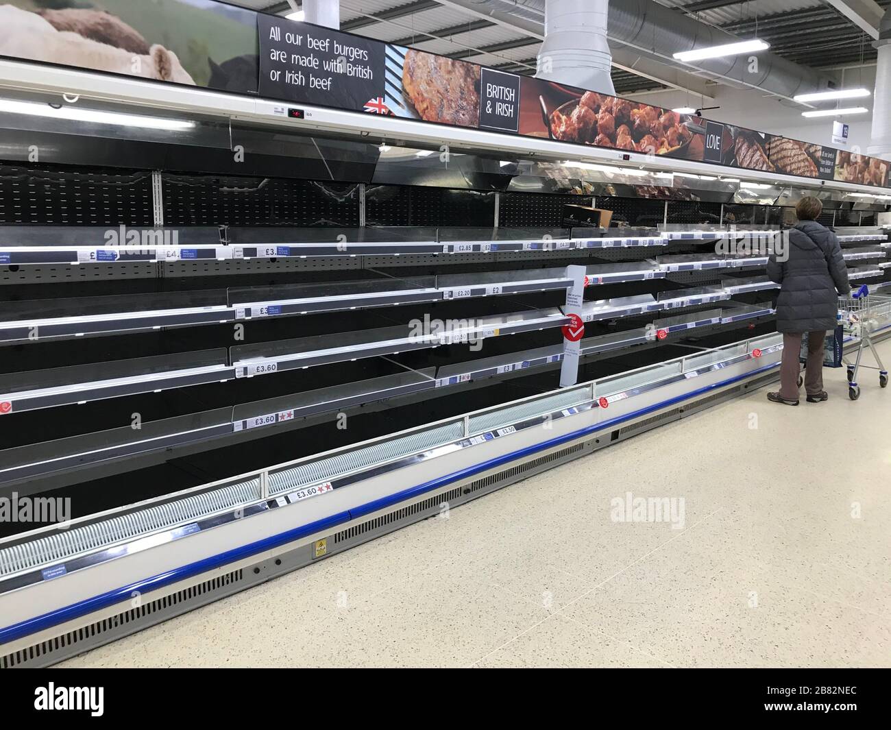 Empty shelves in a tesco extra store in worthing hires stock