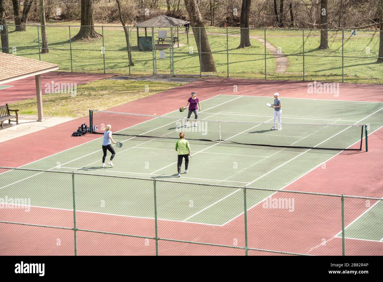 Group of women playing paddleball on warm spring day. Stock Photo
