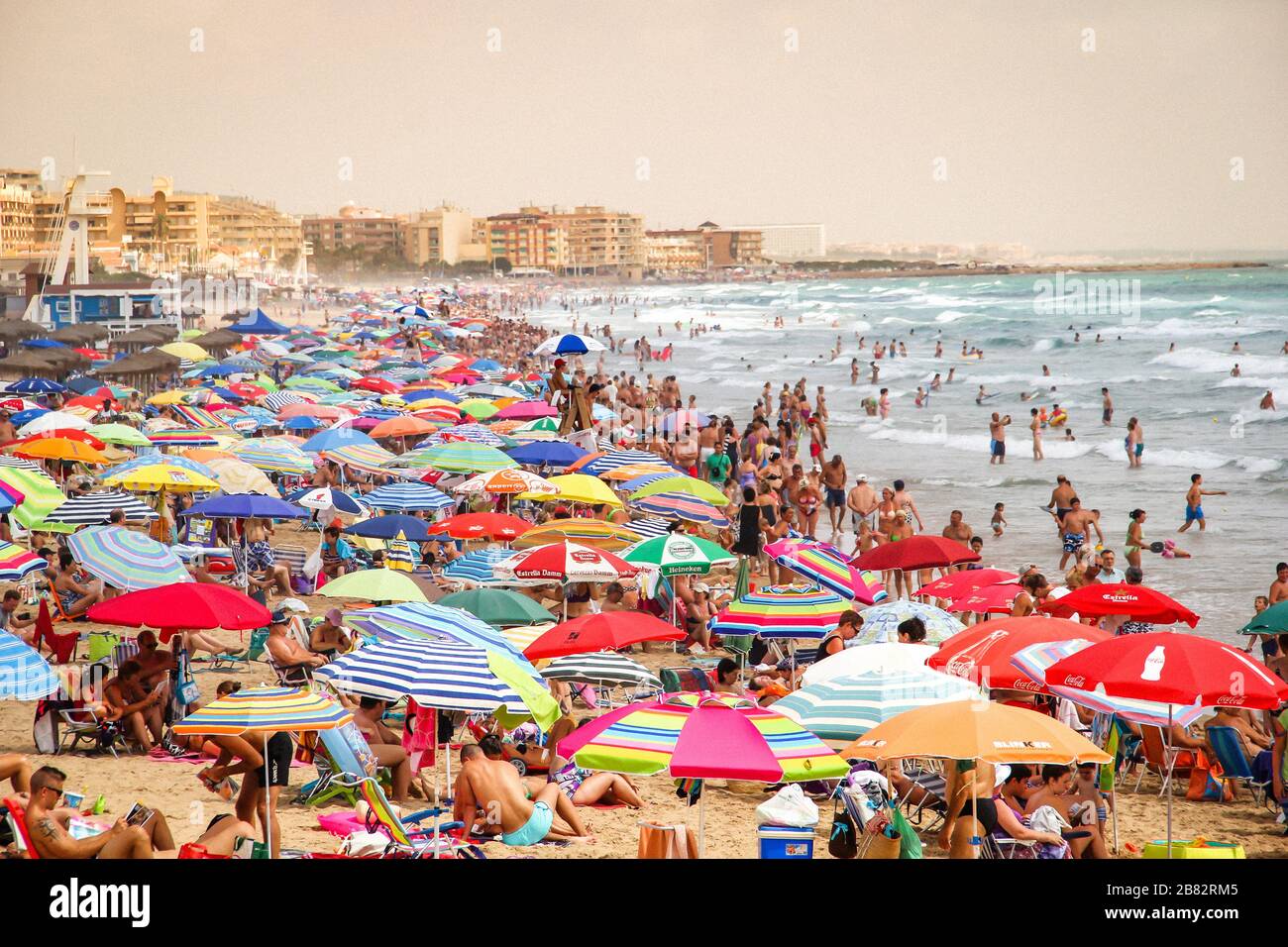 Crowded Beach with Colorful Umbrellas Stock Photo Alamy