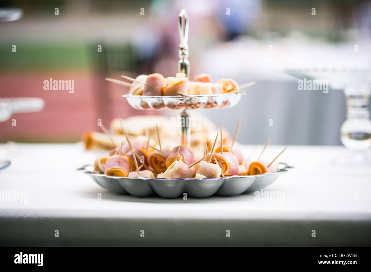 Skewers of cut meat and cheese at outdoor wedding reception Stock Photo