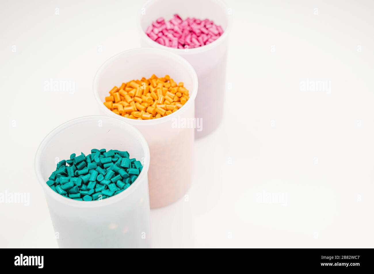 Plastic granules close up for holding,Colorful plastic granules with white background. and dollar money,Plastic Business,Plastic industry. Stock Photo