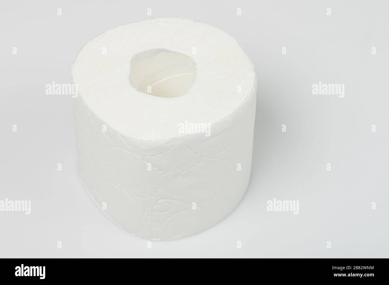 New roll of toilet paper stand on white studio background Stock Photo