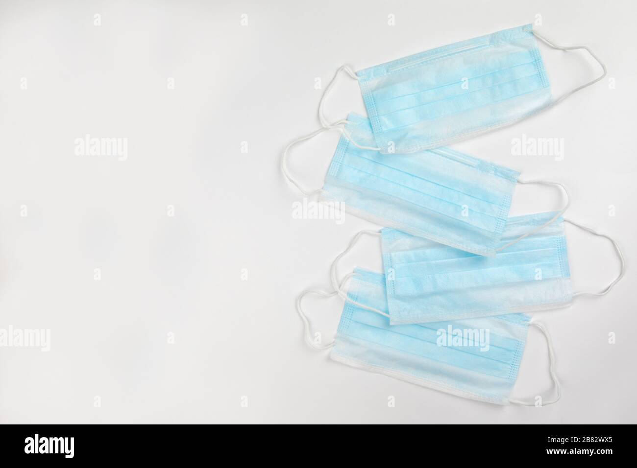 blue surgical medical masks on white background Stock Photo - Alamy