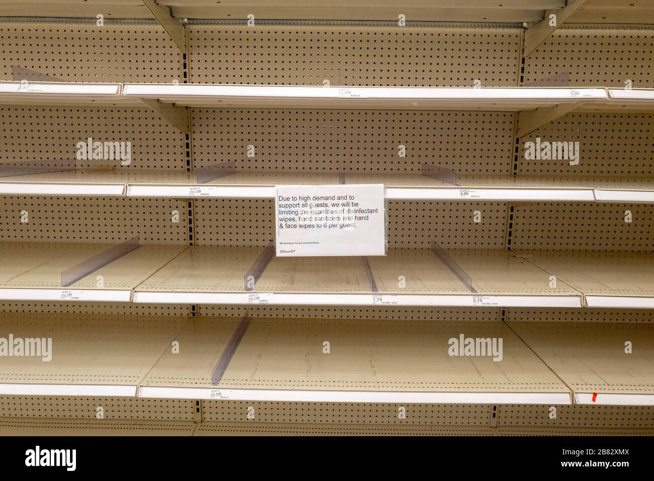 Empty shelves and a sign regarding product rationing are visible at a Target retail store in Contra Costa County, San Ramon, California, as residents purchase all available stock of toilet paper, paper towels, canned goods, hand sanitizer and other essential items during an outbreak of the COVID-19 coronavirus, March 12, 2020. () Stock Photo