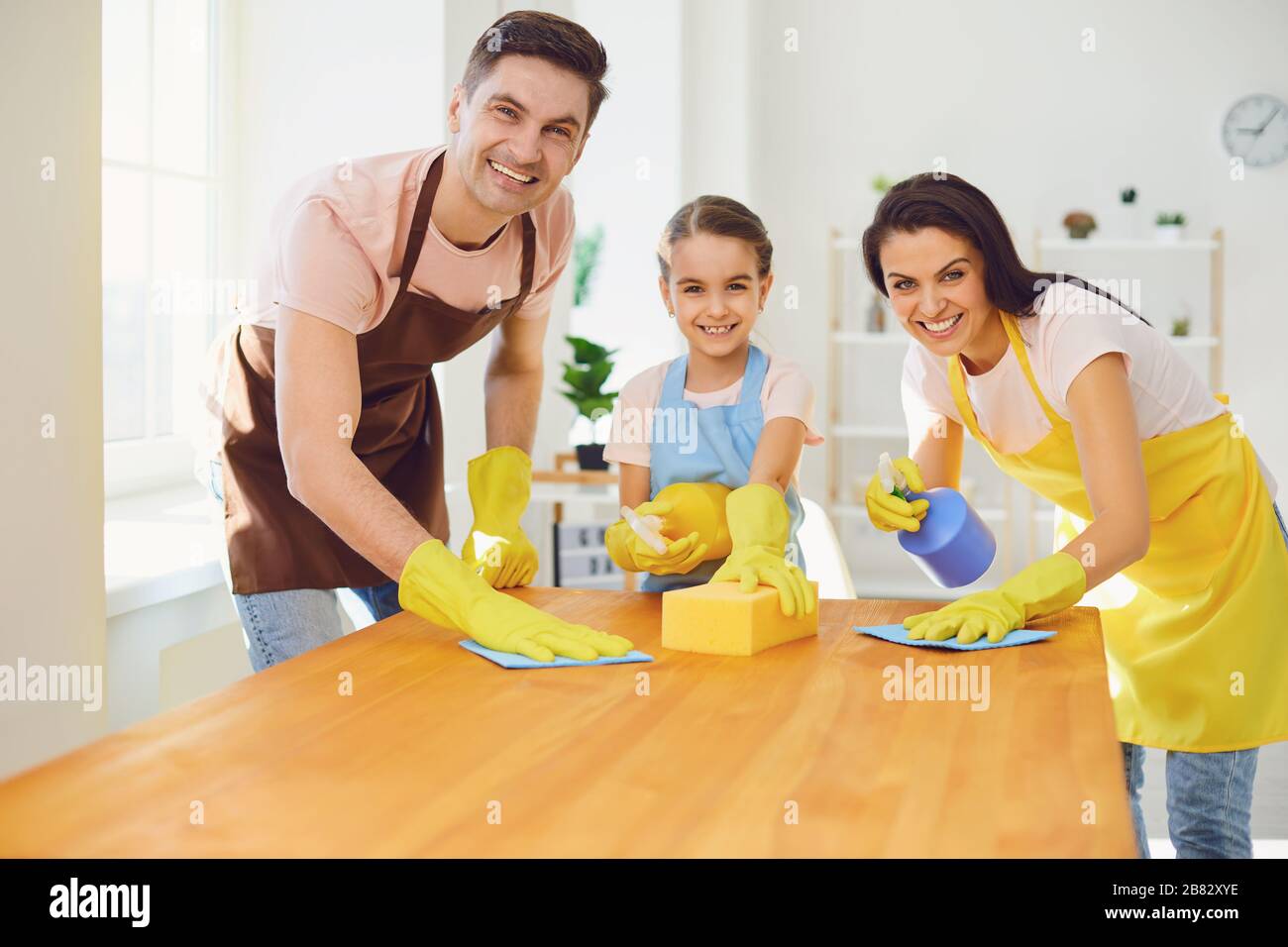 Happy family cleans the room in the house. Stock Photo