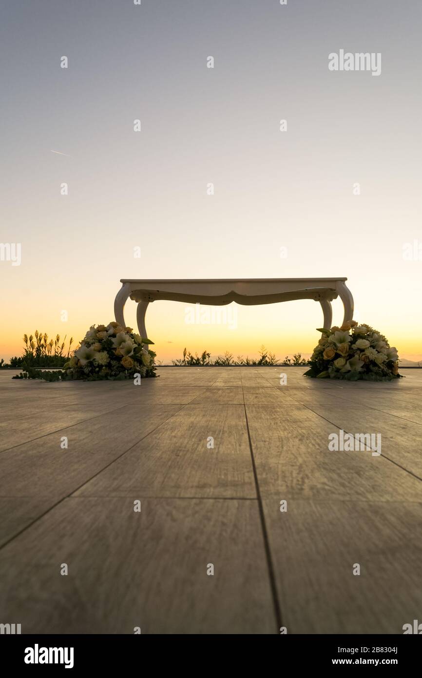 Beautiful white wedding celebration table with floreal decoration on a wide outdoor terrace Stock Photo