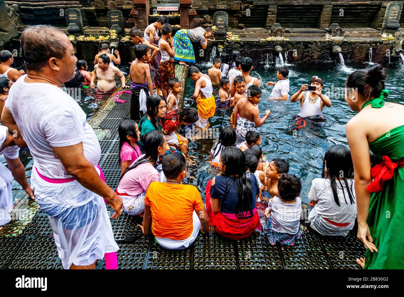 Balinese Visitors Bathing In The ‘Holy Spring’ Pools During A Hindu Festival, Tirta Empul Water Temple, Bali, Indonesia. Stock Photo