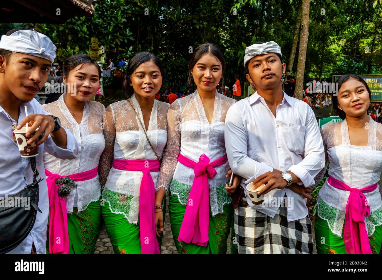 A Group Of Young People In Traditional Costume At A Hindu Festival, Tirta Empul Water Temple, Bali, Indonesia. Stock Photo