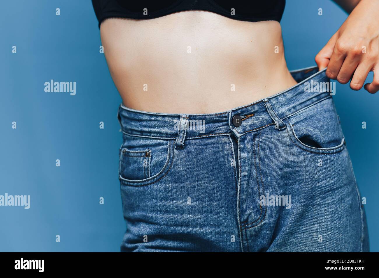 skinny woman body with Loose pants jeans, Light weight body with loose  clothes, slender and Healthy body low fat concept Stock Photo - Alamy