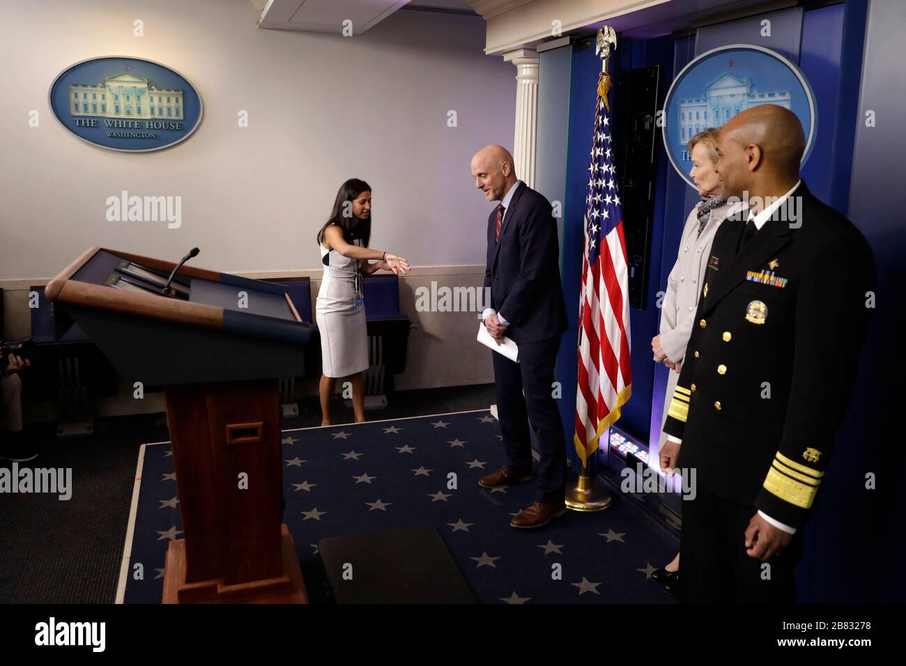 Katie Waldman, Mike Pence's Press Secretary, asks Stephen Hahn, Commissioner, United States Food and Drug Administration (FDA) to move before US President Donald Trump's briefing on the Coronavirus COVID-19 pandemic at the White House in Washington on March 19, 2020. Looking on at right are Dr. Deborah L. Birx, White House Coronavirus Response Coordinator and US Surgeon General Vice Admiral (VADM) Jerome M. Adams, M.D., M.P.H.Credit: Yuri Gripas/Pool via CNP | usage worldwide Stock Photo