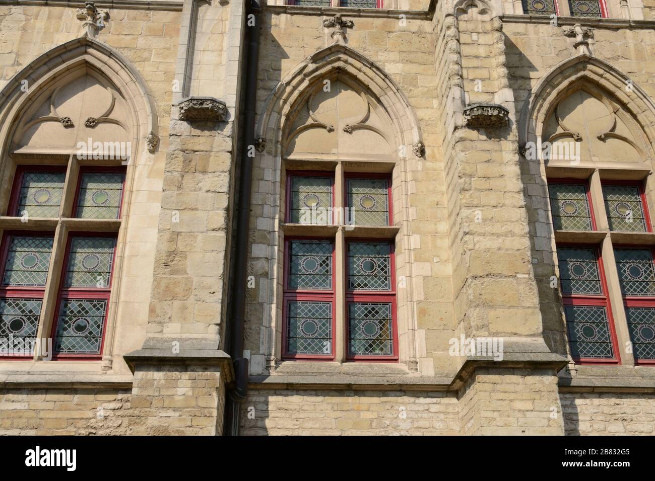 Stained glass windows on historic facade in the old town of Ghent ...
