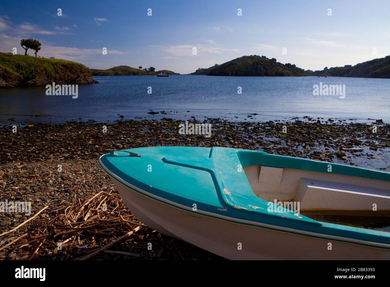 A boat standing on the shore of Port Lligat village in Costa Brava, Girona, Spain. Stock Photo