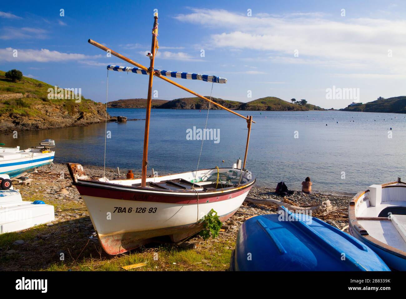 Some boats standing on the shore of Port Lligat village in Costa Brava, Girona, Spain. Stock Photo