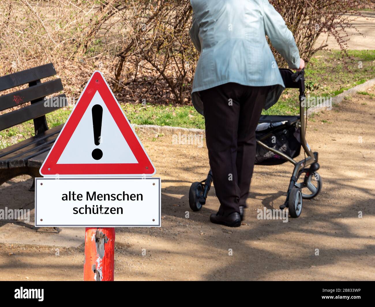 Danger Corona Virus Warning Sign Old People in german Stock Photo