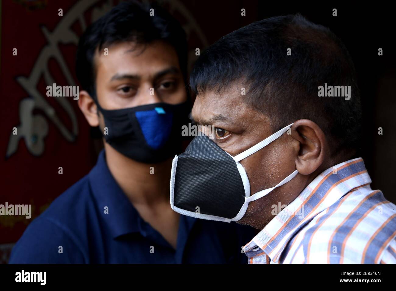 (200319) -- DHAKA, March 19, 2020 (Xinhua) -- People wearing face masks wait for bus at a station in Dhaka, Bangladesh, on March 19, 2020. A total of 17 cases of COVID-19 have been confirmed in Bangladesh with three more testing positive for the virus on Thursday. (Str/Xinhua) Stock Photo