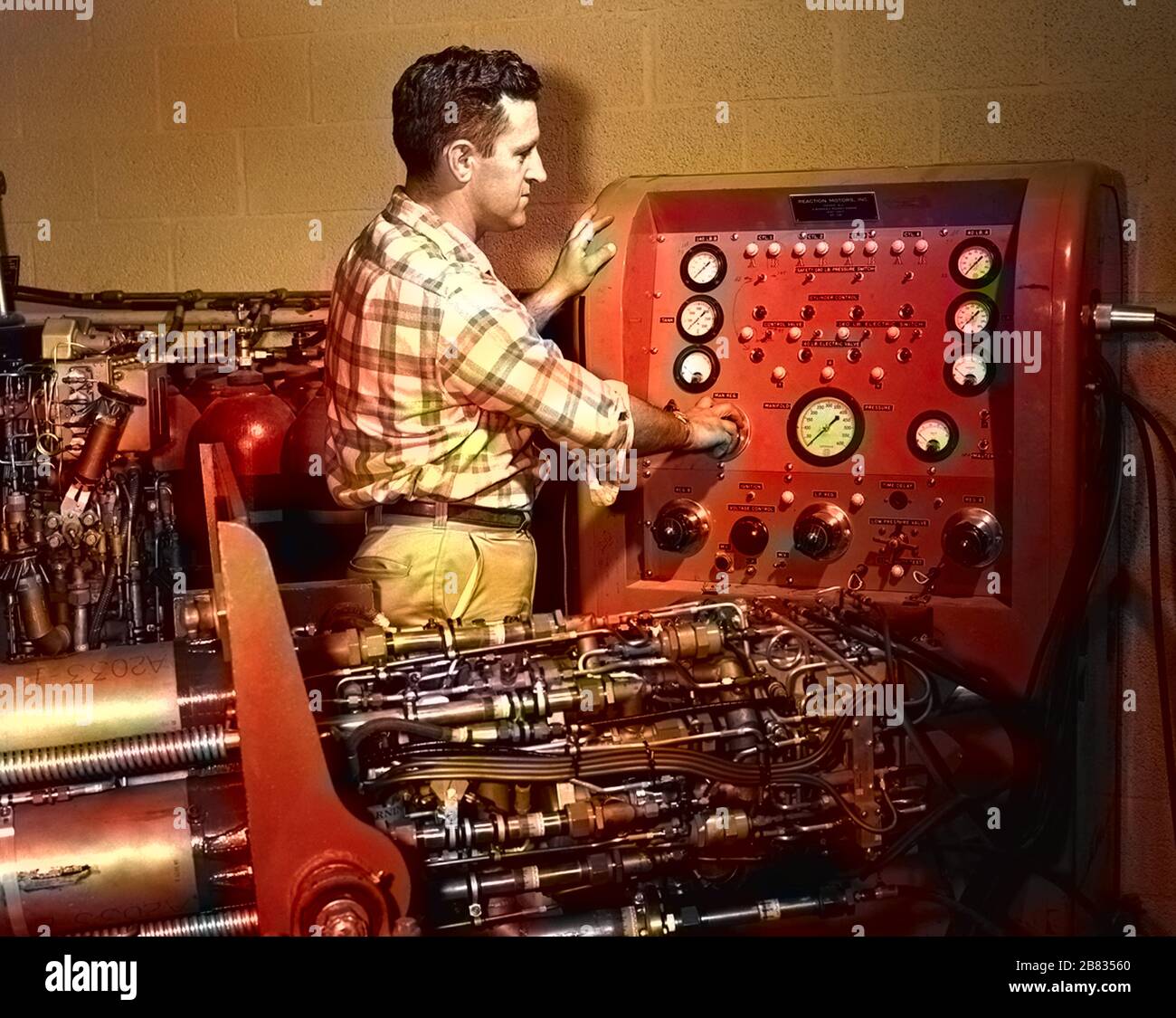 NASA engineer Jack Russell preparing to do pressurization tests on the XLR-11 rocket engine at NACA High-Speed Flight Station Rocket Shop, Armstrong Flight Research Center, Edwards Air Force Base, California, 1956. Image courtesy National Aeronautics and Space Administration (NASA). Note: Image has been digitally colorized using a modern process. Colors may not be period-accurate. () Stock Photo
