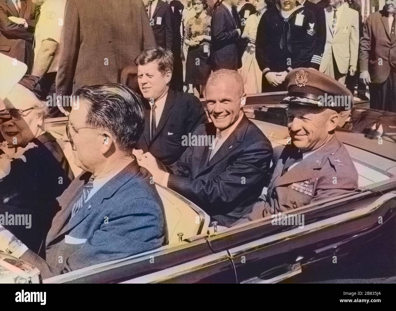 President John F. Kennedy, John Glenn and General Leighton I. Davis riding in a car during a Cocoa Beach parade, Cocoa Beach, Florida, February 23, 1962. Image courtesy National Aeronautics and Space Administration (NASA). Note: Image has been digitally colorized using a modern process. Colors may not be period-accurate. () Stock Photo