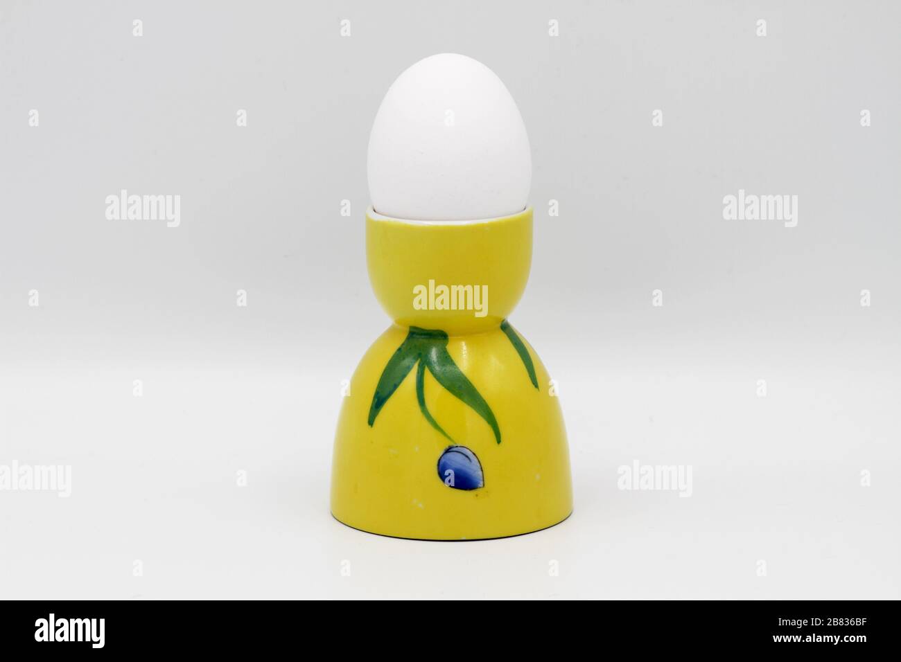 Yellow Egg Cup on White Stock Photo