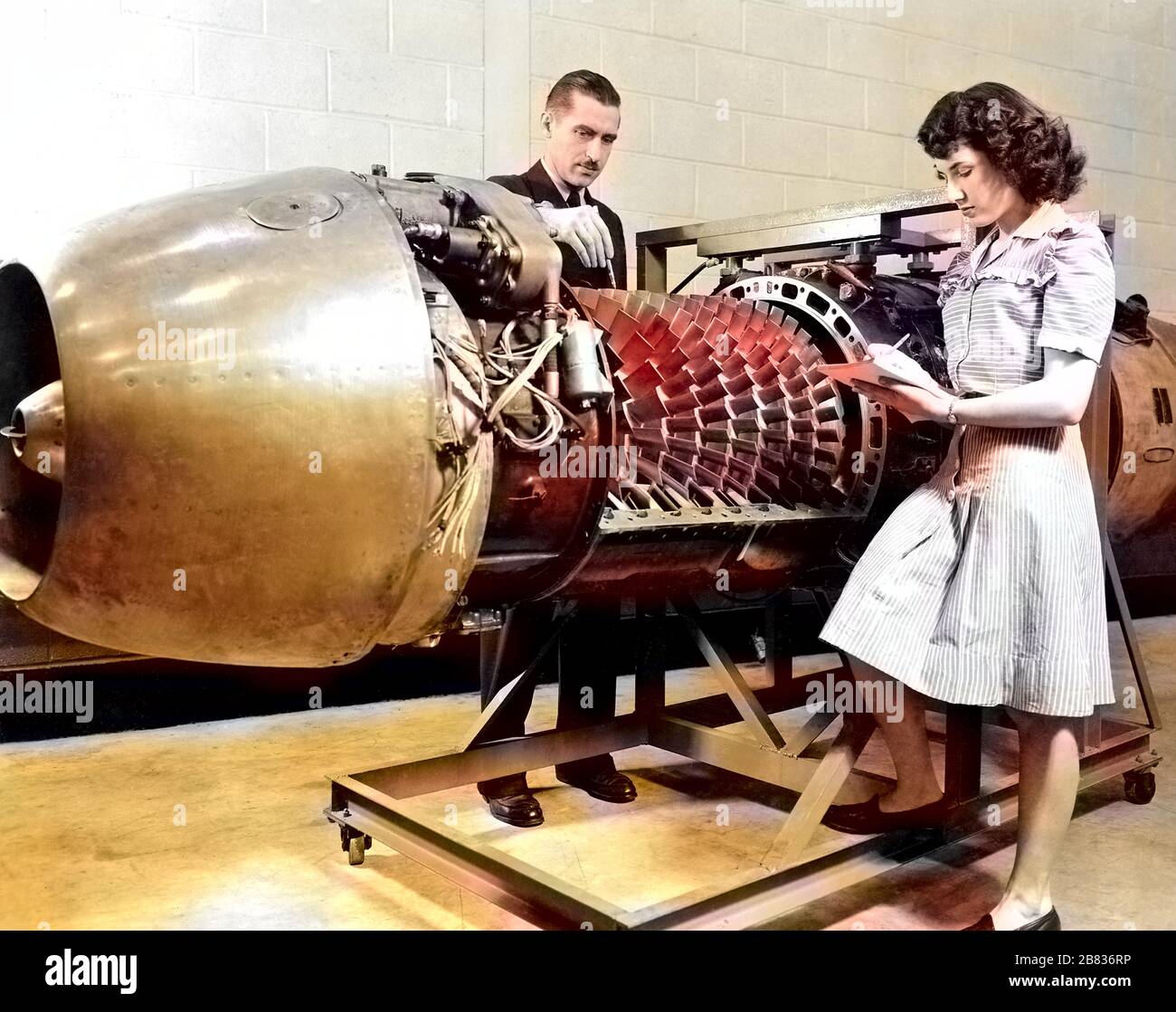 NASA employees inspecting the JUMO 004 Jet Engine with the cover removed at the Aircraft Engine Research Laboratory of the National Advisory Committee for Aeronautics (NACA), Cleveland, Ohio, March 24, 1946. Image courtesy National Aeronautics and Space Administration (NASA). Note: Image has been digitally colorized using a modern process. Colors may not be period-accurate. () Stock Photo